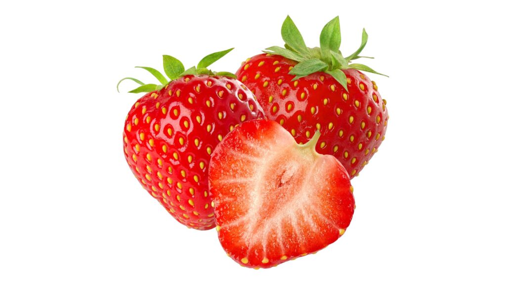 Fresh, red strawberries, one of them cut open, with green leaves on a white background.